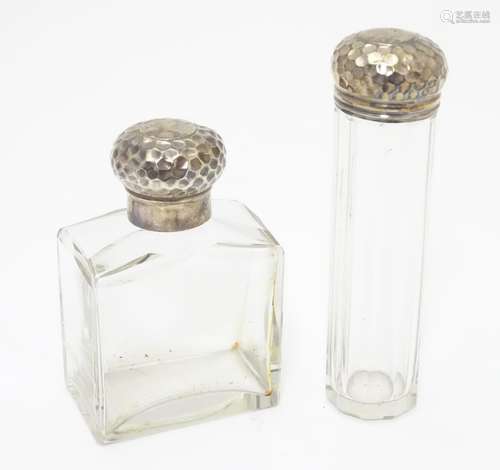 A silver lidded glass scent bottle and a matching silver lidded glass vanity bottle, both lids