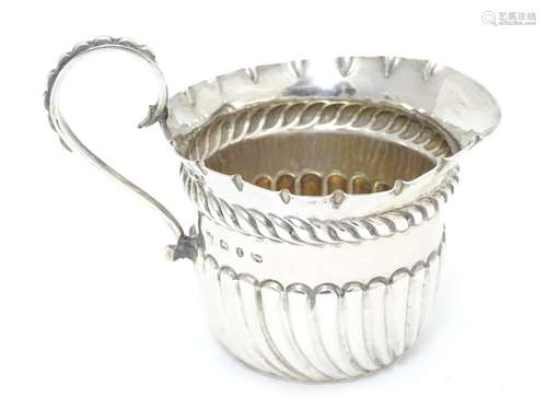 A Victorian silver cream jug with fluted decoration. Hallmarked Birmingham 1891 maker Vale