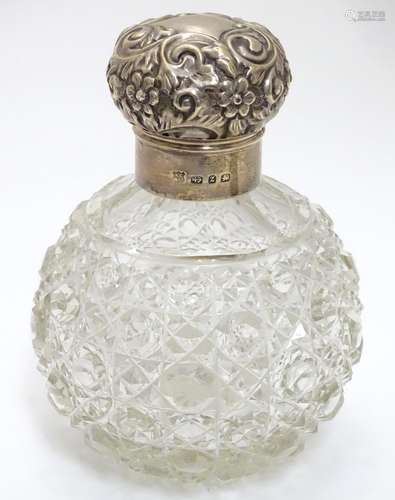 A cut glass scent bottle of spherical form with silver mounts and top hallmarked Birmingham 1899