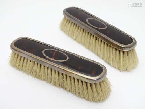 A pair of silver and tortoiseshell mounted clothes brushes. Hallmarked Birmingham 1922 maker