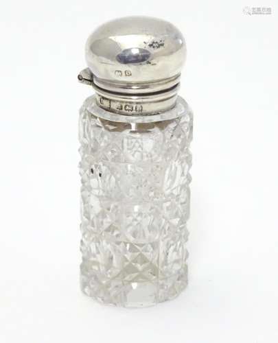 A cut glass scent / perfume bottle with silver mount and lid, hallmarked Birmingham 1913. 2 1/2