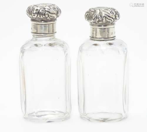 A pair of Victorian cut glass perfume / vanity bottles with silver lids hallmarked London 1892. 3
