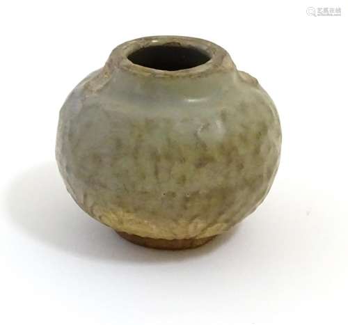 A small Chinese celadon pot with stylised leaf detail in relief. Approx. 2 1/2