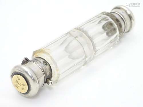 A 19thC double ended scent bottle / flask the class body with white metal ends and yellow metal