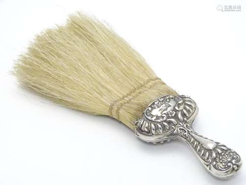 A silver handled hat brush with embossed decoration. Hallmarked Chester 1902 maker J C Plimpton & Co