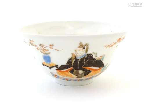 A Japanese small bowl depicting seated figures, a male figure in robes to one side, and a female