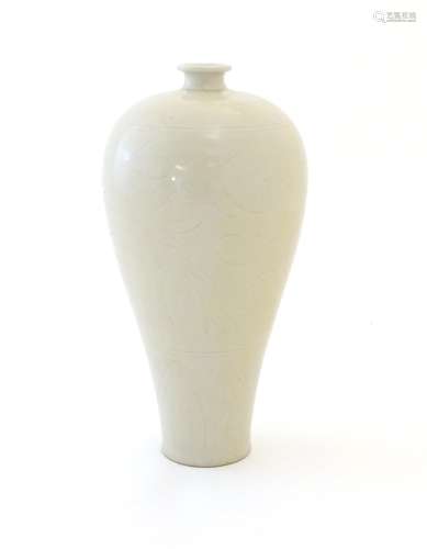 A Korean slender baluster vase with incised stylised floral and foliate detail. Approx. 11 1/2