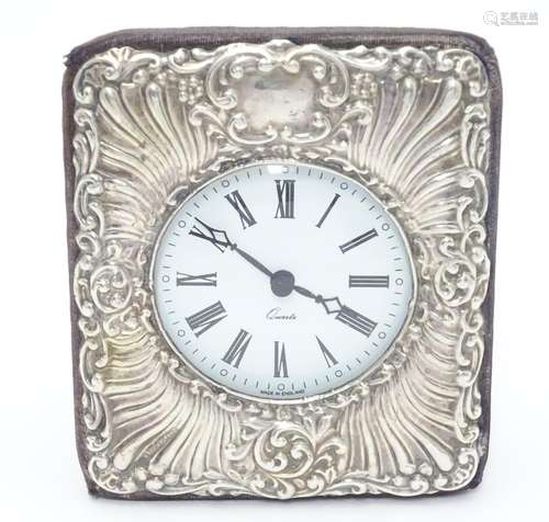 An easel back clock with silver surround. Hallmarked London 1990 maker Keyford Frames Ltd. 4 1/2