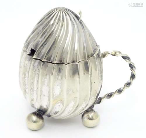 A silver plate mustard pot with hinged lid loop handle and three ball feet. 3