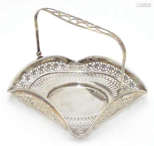 An American Sterling silver swing-handled bonbon dish of square form with pierced decoration.