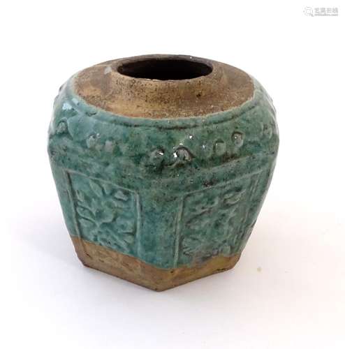 A Chinese hexagonal Shiwan ginger jar / vase with moulded floral and foliate detail with a blue /