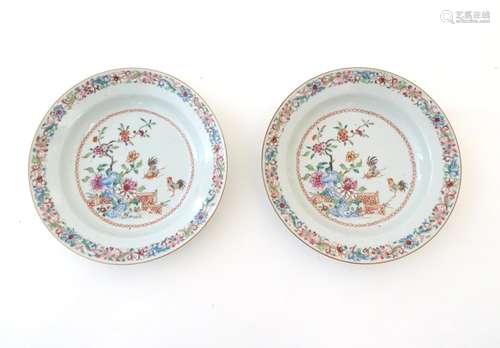 A pair of Chinese dishes decorated with a garden / terrace scene with flowers and foliate with two