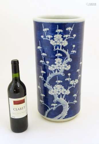 A Chinese blue and white large vase / stick / umbrella stand with prunus blossom detail. Approx.