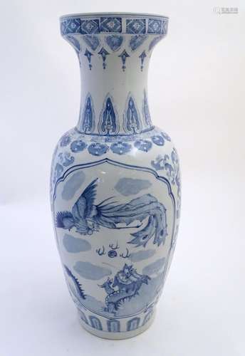 A large Chinese blue and white vase decorated with flowers, foliage and a stylised phoenix and