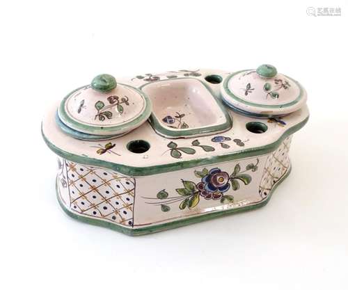 A Continental faience standish with two lidded inkwells and floral and foliate detail. Approx. 3 1/