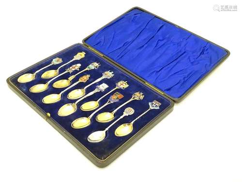 12 assorted silver souvenir teaspoons with enamel direction to handles depicting town coat of arms