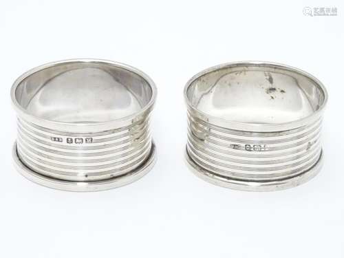 A pair of silver napkin rings with engine turned banded decoration. Hallmarked Birmingham 1921 maker