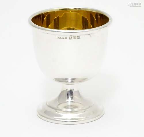 A silver egg cup with gilded interior and weighted base. Hallmarked Birmingham 1963 maker Angora