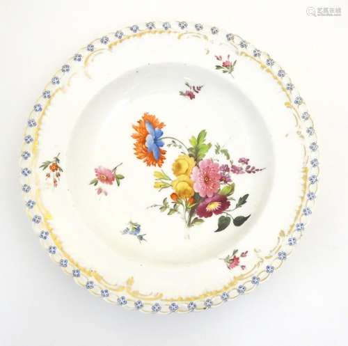 A 19thC porcelain soup dish with hand painted flower detail and gilt highlights. Approx. 10