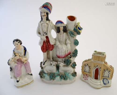 Three items of Staffordshire pottery, to include a figural bud vase, a flatback house and a figure