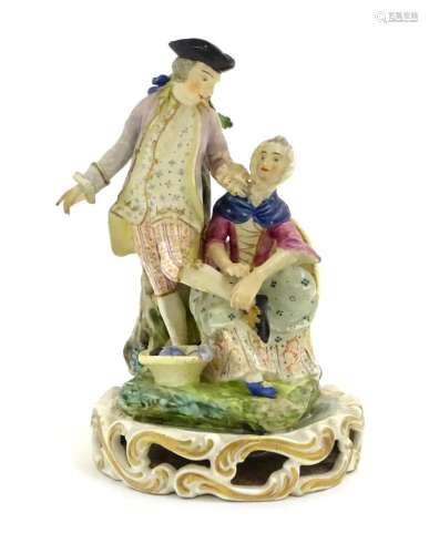 A Continental porcelain figural group depicting a shoe shine girl shining a gentleman's shoes in a