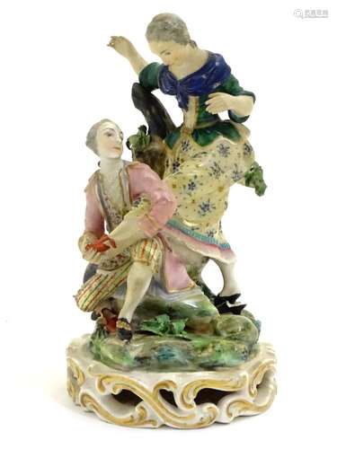 A Continental porcelain figural group with two figures, a kneeling gentleman fitting a slipper on