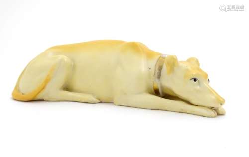A 20thC porcelain model of a recumbent greyhound dog with a gilt collar. Approx. 8 1/4