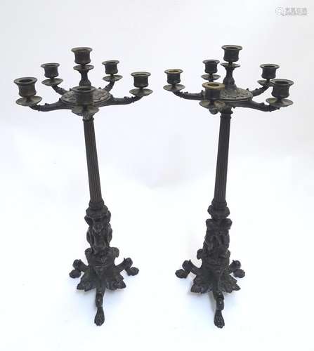 A pair of Regency bronze candelabra, the fluted columns supporting a series of five candle cups