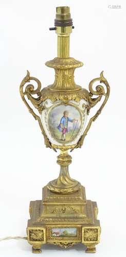 A 20thC Continental table lamp, the urn shaped body with gilt metal mounts and hand painted scene