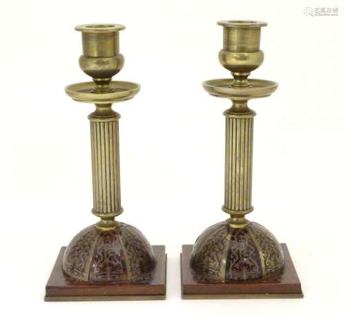 A pair of 19thC Regency brass and tortoiseshell Boulle candlesticks with domed square bases and