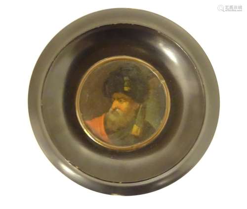 A 19thC oil on card portrait miniature depicting a bearded man wearing a fur hat, possibly a Russian