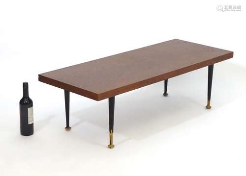 A mid 20thC Meredew coffee table with a rectangular teak top above four turned tapering legs.