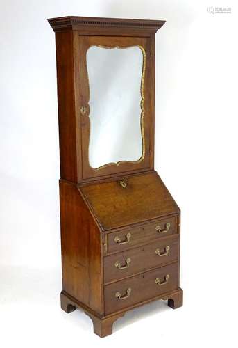 A Regency mahogany bureau bookcase with a moulded cornice above a dentil frieze and shaped