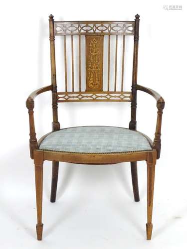 An early 20thC rosewood chair with an inlaid frame and having pierced decoration to the backrest,