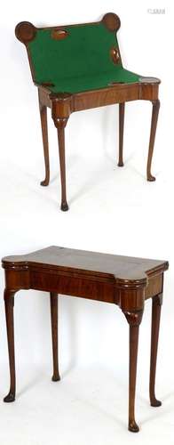 A George I walnut card table with castellated corners, opening to show a baize playing surface and