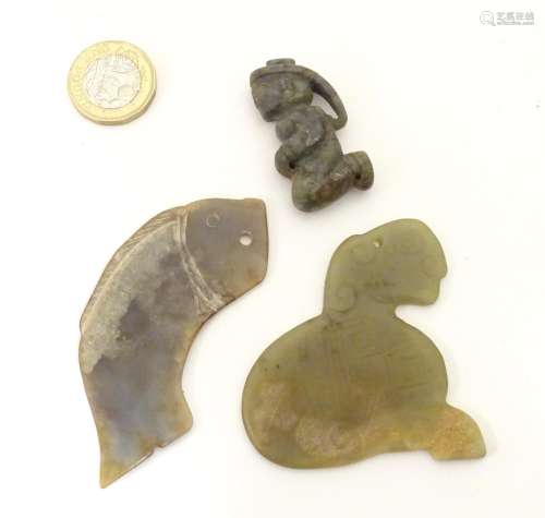 Three Chinese stone carvings / amulets / pendants, comprising a carved kneeling figure, a stylised