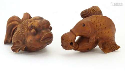 A carved netsuke modelled as two fish, together with a model of a fish. Largest approx. 2