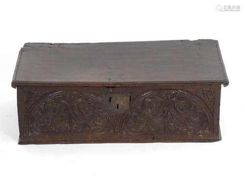 A late 17thC carved oak bible box with floral lunette decoration. 26