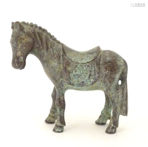 An Oriental bronze model of standing horse with saddle. Approx. 4