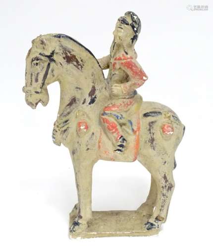 A Chinese model of a figure on horseback with polychrome decoration. Approx. 9 1/2