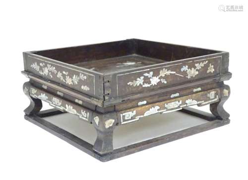 A Chinese hardwood stand of squared form with decorative abalone inlay. Approx. 3 1/2