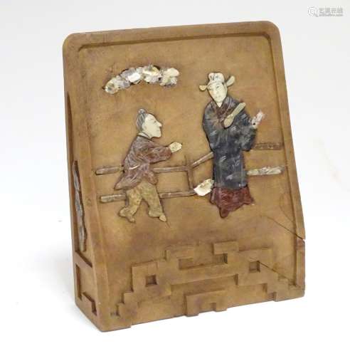 A Chinese carved wooden bookend with inlaid soapstone and shell depicting two figures on a