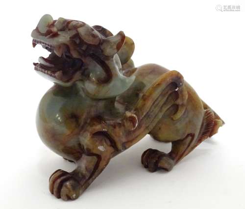 A Chinese carved soapstone model of a stylised foo dog. Approx. 4 1/4