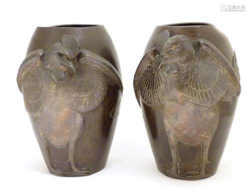 A pair of late 19th / early 20thC Japanese bronze vases with relief cockerel decoration.