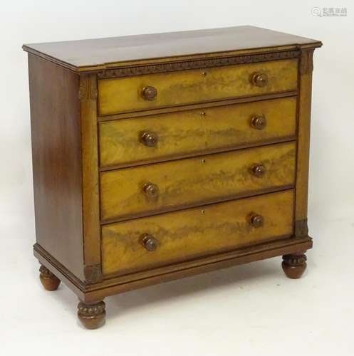 An early 19thC mahogany chest of drawers with a crossbanded inverted breakfront top above a carved