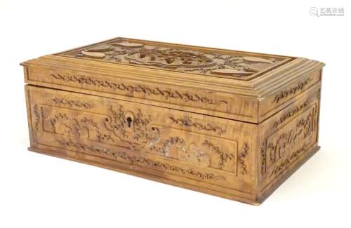 A camphor wood box with carved floral and foliate detail, the lid with a carved vignette depicting