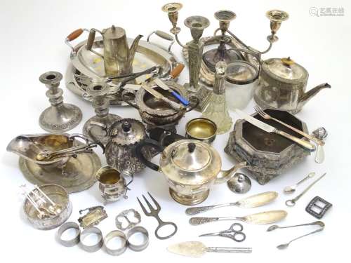 A large equanimity of assorted silver plated wares to include candlesticks, flatware, serving