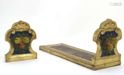 An Italian style carved book slide with gilt and polychrome decoration, the supports decorated