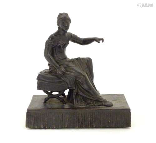 A 19thC bronze figure of a woman seated on an x-frame stool mounted on a fringed rectangular base.