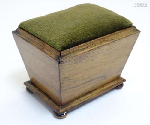 A 19thC rosewood pin cushion of sarcophagus form with four bun feet. Approx. 4 1/4